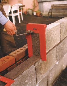 a man is cutting bricks with a pair of scissors