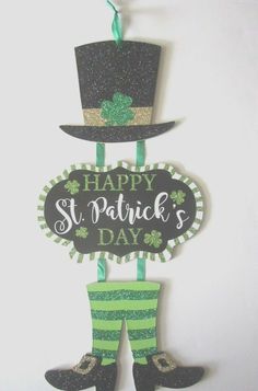 a st patrick's day sign hanging on the wall with a hat and boots