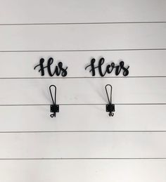 two hooks are attached to the side of a wall that reads, flosss