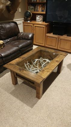 a living room with leather couches and a wooden coffee table in the center area