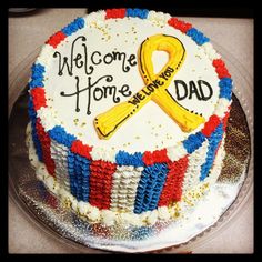 a decorated cake with the words welcome home and a yellow ribbon for dad on it