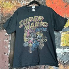 Vintage Super Mario Bros. T-shirt. Size Larg (LAST ONE) We ship worldwide. Thank you for your shopping. Retro Mario, Mario Shirt, Mario Brothers, Cartoon T Shirts, Mens T Shirts, Super Mario Bros, Mario Bros, Mens Graphic Tee, Buy Vintage