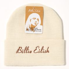 a white beanie with a label on it that says, bille elish