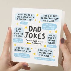 a person holding up a card with the words dad jokes written in black on it