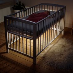 there is a small crib that has a blanket on top of it and the text, share device access via the safety 1st connected app