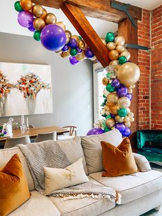 a living room filled with furniture and balloons