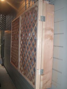 a large wooden box sitting on the side of a building