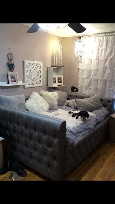 a living room filled with furniture and lots of pillows on top of it's couch