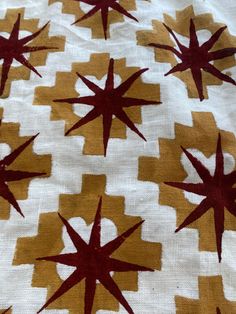 a white and yellow blanket with red stars on it