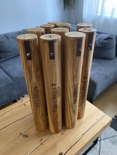 four wooden vases sitting on top of a table in front of a blue couch