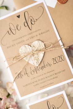 the wedding stationery is tied up with twine