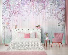 a bedroom decorated in pink and white with a floral wall mural behind the headboard