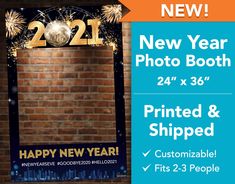 a happy new year photo booth sign with fireworks in the background and an orange brick wall