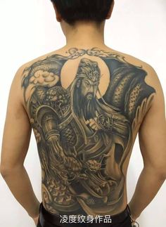 the back of a man with tattoos on his body