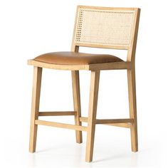 a wooden chair with a brown leather seat and back rest on a white background,