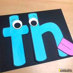 the letter h is made out of construction paper and cut into two different shapes with eyes