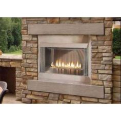 an outdoor fireplace with lit candles on it