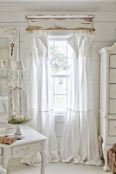 a white room with a window and curtains