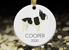 a white ornament with a black boston terrier on it