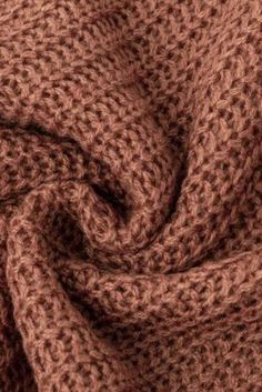 a close up view of a brown knitted fabric