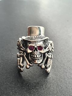 925 sterling silver Top Hat Redeye Skull Ring -------------------------------------------------------------------------- All our silver jewelry are 925 stamped. 📦 FREE SHIPPING Due to the current Global Health Issue, Shipping delays may occur in your designated countries. 🔸️All items shipped within Canada Domestic) are Expedited Parcel (Canada Post) with tracking number. Package delays usually occur up-to 2-3 business days as per our assessment. 🔸️Items Shipped to USA International) are Track Collectible Gothic Skull Ring, Gothic Skull Ring Stamped 925, Collectible Skull Ring For Halloween, Collectible Skull Rings For Halloween, Silver Symbolic Skull Ring For Halloween, Symbolic Silver Skull Ring For Halloween, Collectible Halloween Skull Ring, Silver Skull Rings Hallmarked, Silver Skull Ring With Hallmark