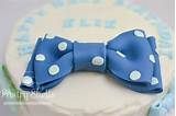 a blue and white cake with a big bow on it