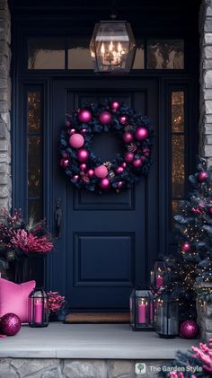 a front door decorated for christmas with pink ornaments