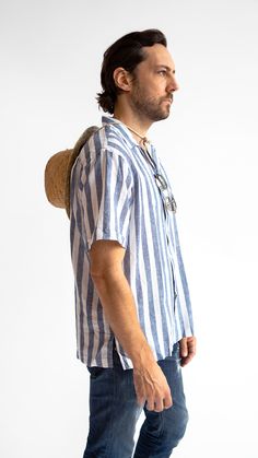 Man wearing striped cabana shirt Casual Shirt For Vacation In Warm Weather, Relaxed Linen Vacation Shirt, Linen Top With Camp Collar For Vacation, Linen Camp Collar Tops For Vacation, Summer Linen Top With Camp Collar, Summer Linen Shirt For Day Out, Relaxed Fit Shirt For Vacation In Warm Weather, Vacation Shirt For Warm Weather In Relaxed Fit, Relaxed Fit Beachwear Shirt For Vacation