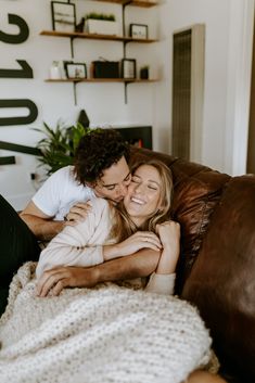 a man and woman cuddling on a couch