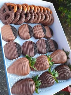 chocolate covered strawberries and cookies are arranged on a white tray in the shape of hearts