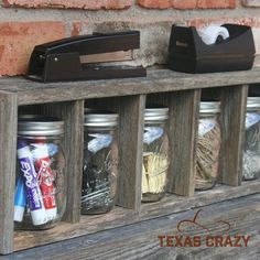 mason jars are lined up on a wooden shelf