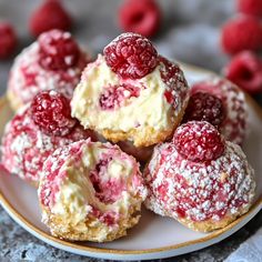 raspberry cheesecake bites on a plate with powdered sugar