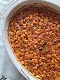 a casserole dish filled with beans and meat