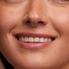 a woman with a nose piercing smiling