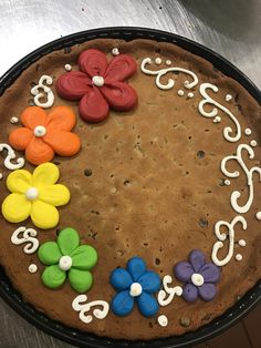 a chocolate cake decorated with flowers and icing