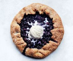 a blueberry pie with ice cream on top