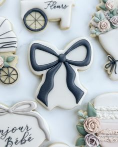 decorated cookies are arranged in the shape of baby carriages and carriages, with ribbons on them