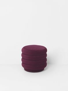 a stack of purple round cushions sitting on top of each other