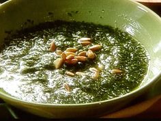 a green bowl filled with food on top of a table