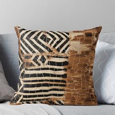 a brown and black pillow sitting on top of a couch