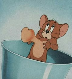 a cartoon mouse sitting in a blue bowl