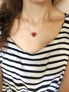 The necklace features a lovely heart shaped red Jasper (natural B-grade) pendant, on a chain with adjustable length from 16" to 18". The gemstone is well cut and has a vivid natural red color. This simple yet elegant and delicate piece can be also added to one of your layering necklaces. The bigger heart size pendant is about 16x16mm. Please refer to pictures of sizes and color. The model in the first picture was wearing a smaller size stone.  Please also note that natural gemstones are unique and imperfection such as lines often appears with jaspers. If you like a specific one in the picture, please feel to msg me. Otherwise I will ship out randomly.  Jasper is a very grounding gemstone. It symbolized the blood of the Earth in some Native America culture. Please be aware that natural jasp Handmade Heart-shaped Red Necklaces, Artisan Red Jasper Necklaces, Red Gemstone Necklace, Red Jasper Spiritual Necklace, Red Jasper Jewelry, Red Jasper Necklace, Red Agate Hand-strung Necklace, Snow Quartz, Healing Stones Necklace