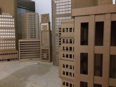 several model buildings are shown in the middle of an empty room with no people around them