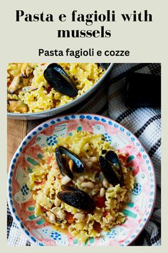 pasta e fagioi with mussels in a bowl on top of a table