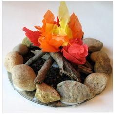 a glass plate filled with rocks and flowers