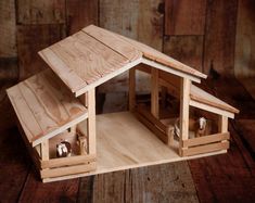 a small wooden house with two bells in it