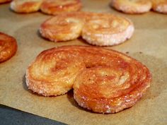 some doughnuts that are sitting on a piece of wax paper and ready to be baked