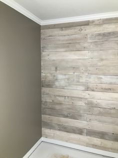 an empty room with wood paneling on the wall and carpet in the floor area