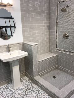 a white sink sitting next to a walk in shower