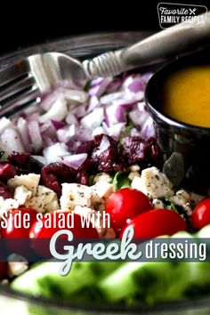 salad with greek dressing on the side in a glass bowl, ready to be eaten